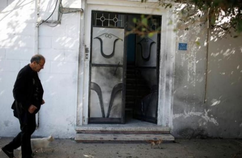 A damaged door of a Fatah official's home after an explosion in Gaza City November 7, 2014 (photo credit: REUTERS)