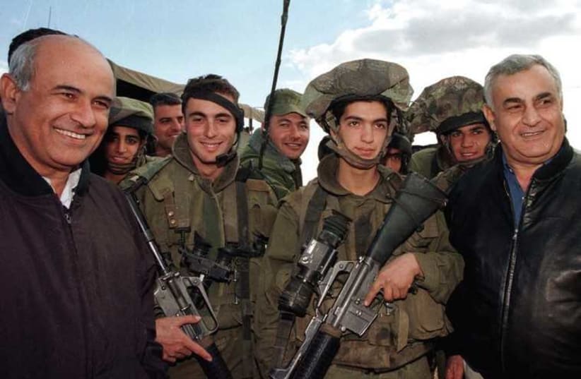 THEN-DEFENSE MINISTER Yitzhak Mordechai and then-Public Security Minister Avigdor Kahalani visit Israeli troops in combat gear near the northern border with Lebanon in 1999. (photo credit: REUTERS)