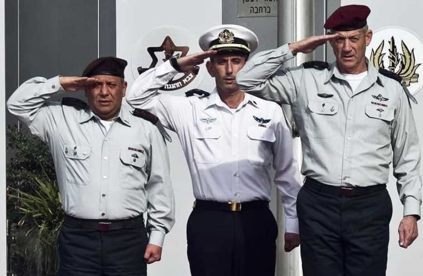 New IDF chief of staff Lieutenant-General Gadi Eizenkot (L) and outgoing chief of staff Lieutenant-General Benny Gantz (R) salute during a handover ceremony in Tel Aviv (photo credit: REUTERS)