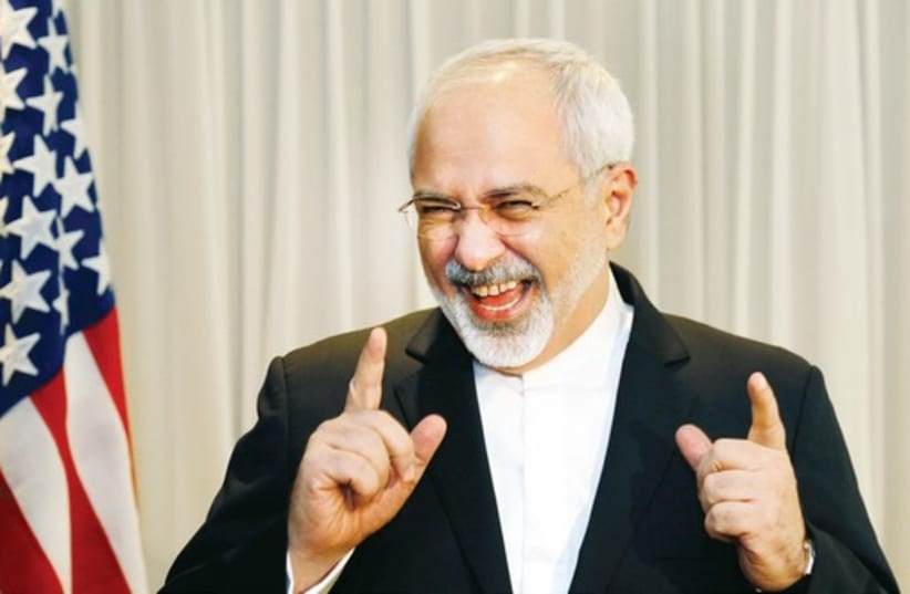 Iranian Foreign Minister Mohammad Javad Zarif talks with reporters before meeting with US Secretary of State John Kerry in Geneva in January. (photo credit: REUTERS)