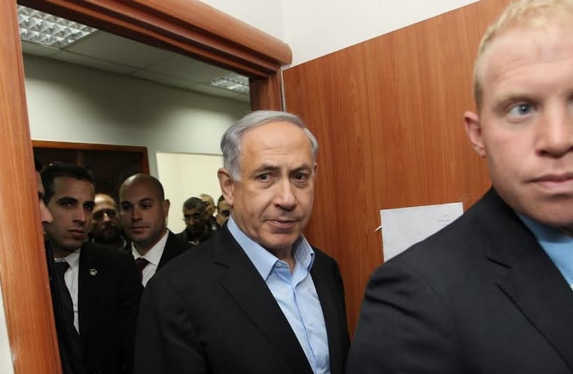 Prime Minister Benjamin Netanyahu entering a meeting in Lod (photo credit: POOL/ ILAN ASSAYAG)