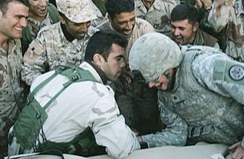 Iraqi US soldier arm wrestle 248.88 (photo credit: AP)