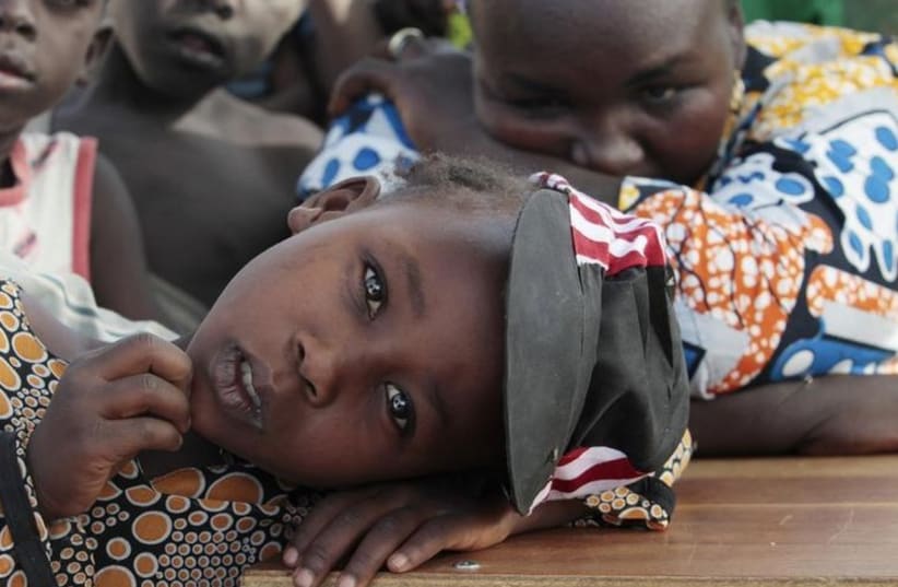 A girl displaced as a result of Boko Haram attack in the northeast region of Nigeria, rests her head on a desk at Maikohi secondary school camp for internally displaced persons (IDP) in Yola (photo credit: REUTERS)