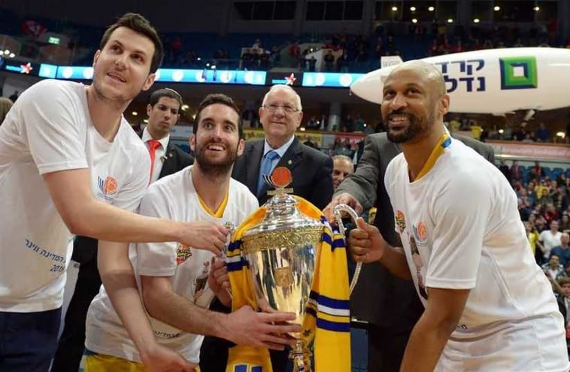 President Reuven Rivlin stands behind Maccabi Tel Aviv players after presenting them with the State Cup. (photo credit: PRESIDENTIAL SPOKESPERSON OFFICE)