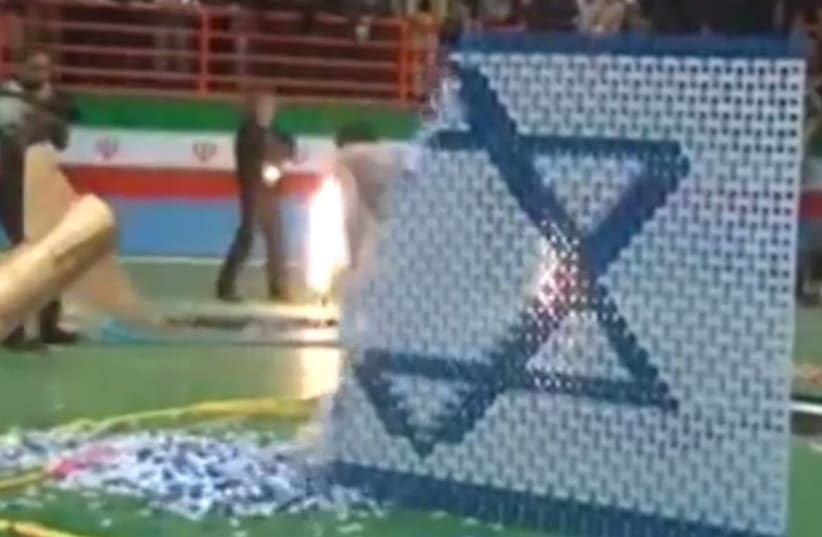 Nuclear-themed domino show in Iran culminates with missile destroying Israeli flag.. (photo credit: MEMRI)