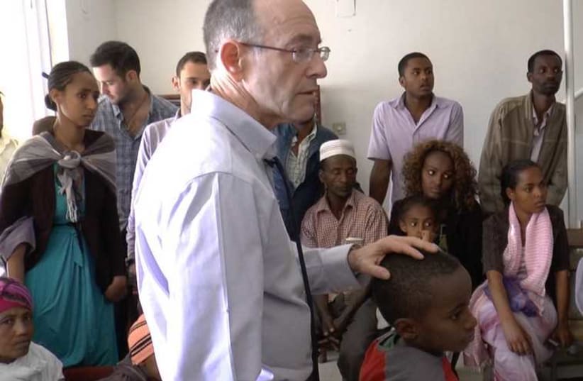 Dr. Rick Hodes speaks in his Addis Ababa clinic to a group of Ethiopian families who are about to send their children to Ghana for spinal surgery (photo credit: BERNARD DICHEK)