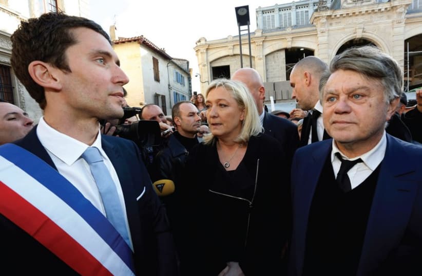 NATIONAL FRONT leader Marine Le Pen (center) attends a gathering to pay tribute to the ‘Charlie Hebdo’ shooting, in the south of France last month (photo credit: REUTERS)