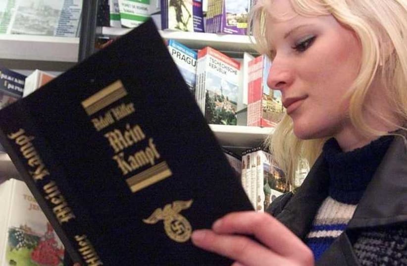 A young Czech woman reads a copy of Hitler's manifesto Mein Kampf in a central Prague's bookstore (photo credit: REUTERS)