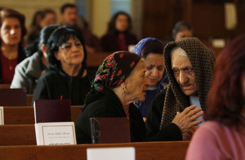 Iraqi Christians attend mass at Mar George Chaldean Church in Baghdad, March 1, 2015. Iraqi Christians say they have no intention of leaving the country despite the recent abduction of over 100 Assyrian Christians by the Islamic State (photo credit: REUTERS)