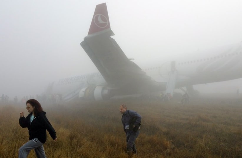 Passengers exit from a Turkish Airlines plane soon after it overshot from the runway in Kathmandu (photo credit: REUTERS)