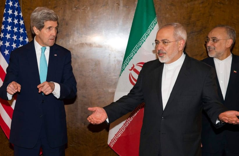 US Secretary of State John Kerry and Iran's Foreign Minister Mohammad Jawad Zarif (C) at nuclear negotiations in Montreux, Switzerland (photo credit: REUTERS)