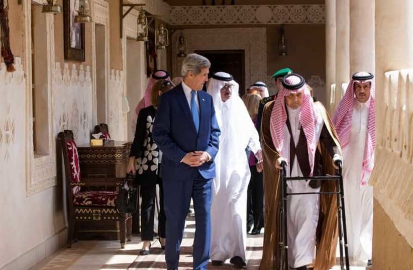 John Kerry (L) walks with Saudi Arabia's FM Saud bin Faisal bin Abdulaziz Al Saud before meeting with Saudi King Salman bin Abdulaziz al-Saud in Diriyah (photo credit: REUTERS)