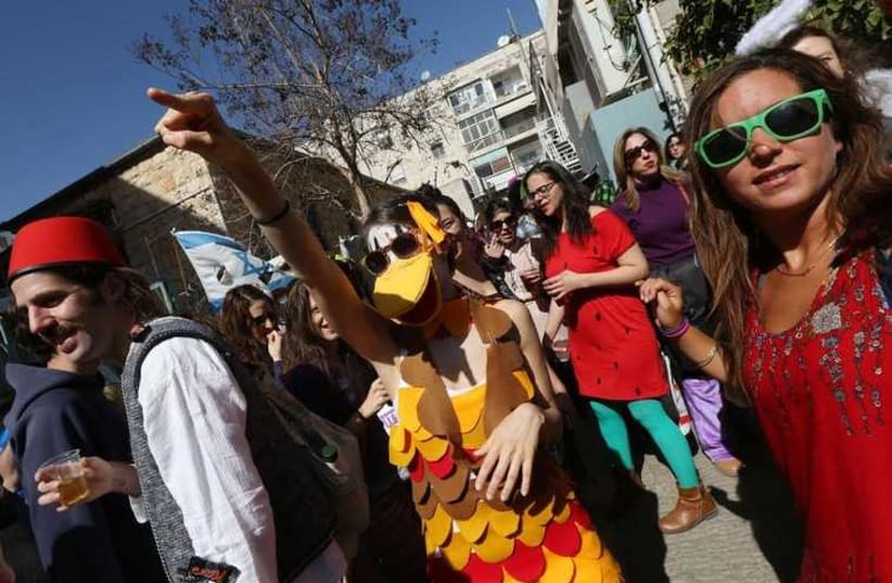 Jerusalemites revel during Purim festivities in the downtown neighborhood of Nahlaot (photo credit: MARC ISRAEL SELLEM)