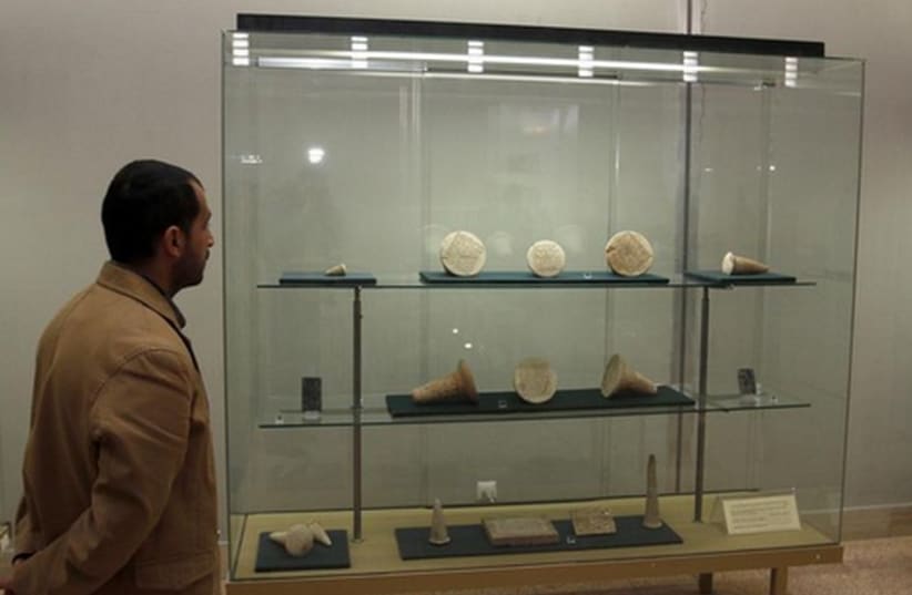 A man looks at artifacts displayed inside the Iraqi National Museum in Baghdad (photo credit: REUTERS)