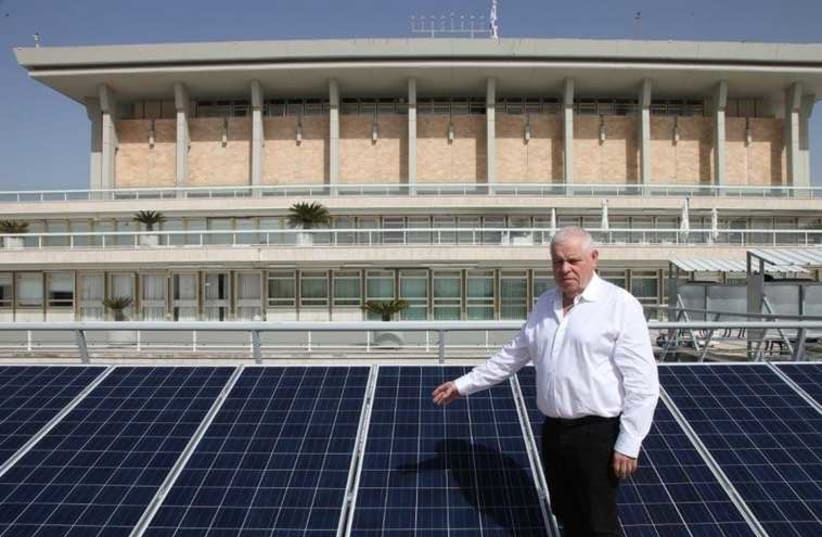 Ronen Plott next to solar panels on Knesset building (photo credit: COURTESY KNESSET)