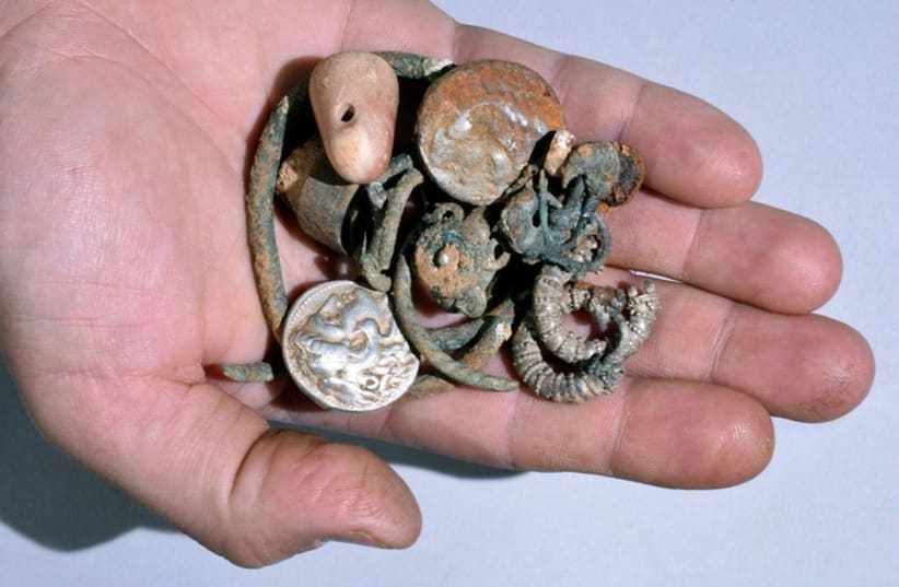Rare 2,300-year-old silver and bronze coins, jewelry found in ancient northern cave (photo credit: COURTESY OF ISRAEL ANTIQUITIES AUTHORITY)