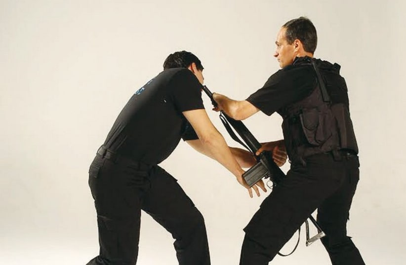 Kobi Lichtenstein (right) demonstrates how to disarm an enemy using Krav Maga. (photo credit: Courtesy)