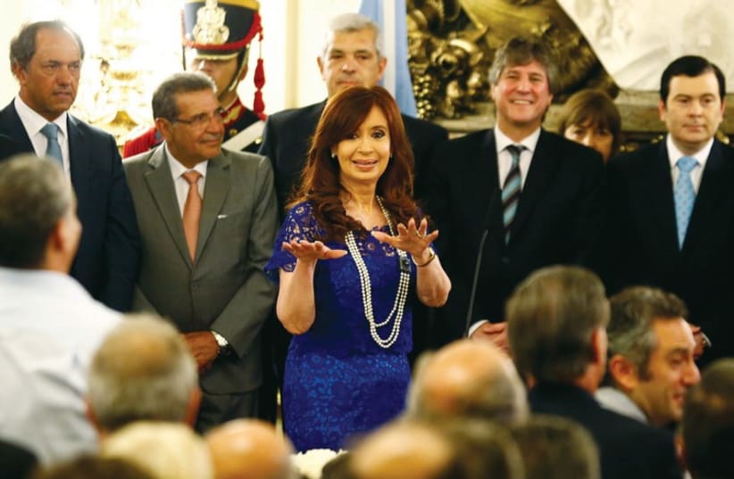 Cristina de Fernandez Kirchner stands with members of her government on February 26.  (photo credit: REUTERS)