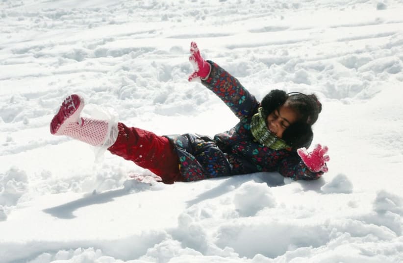 A child plays in the snow in Jerusalem in February. (photo credit: MARC ISRAEL SELLEM/THE JERUSALEM POST)