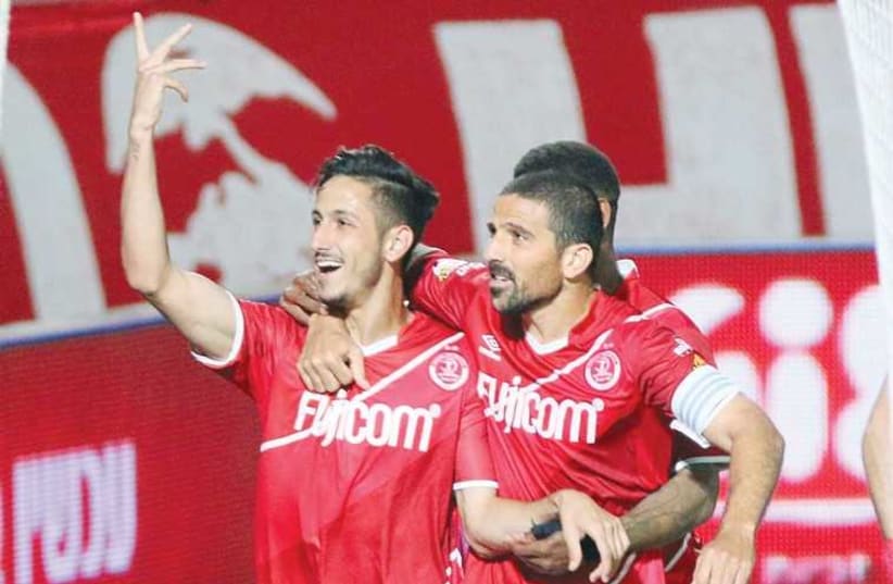 Hapoel Tel Aviv striker Sagiv Yehezkel (left) celebrates with Moshe Ohayon. (photo credit: ADI AVISHAI)