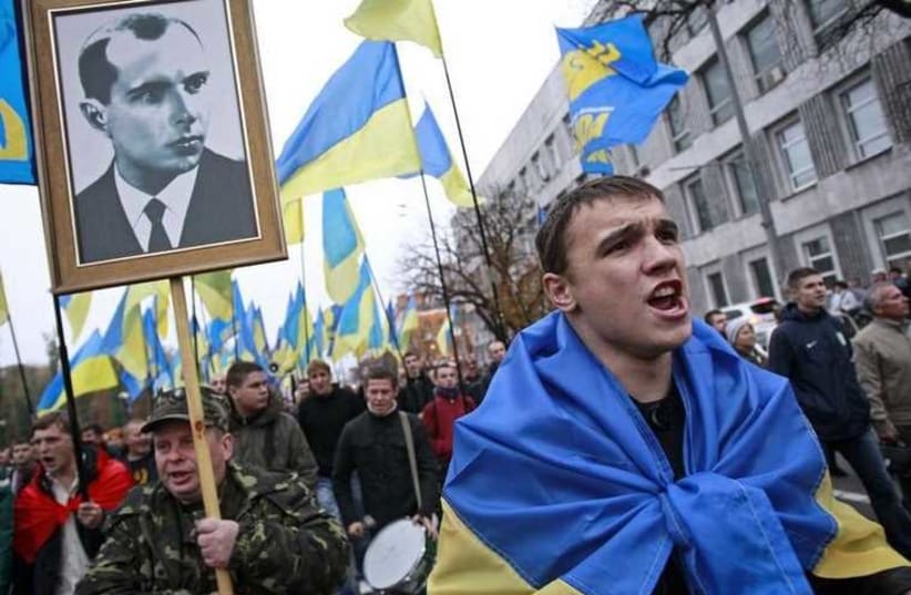 Portrait of UPA leader Stepan Bandera (left) at a rally marking the anniversary of the Ukrainian Insurgent Army (UPA), which fought both Nazi and Soviet forces in World War II [File] (photo credit: REUTERS)