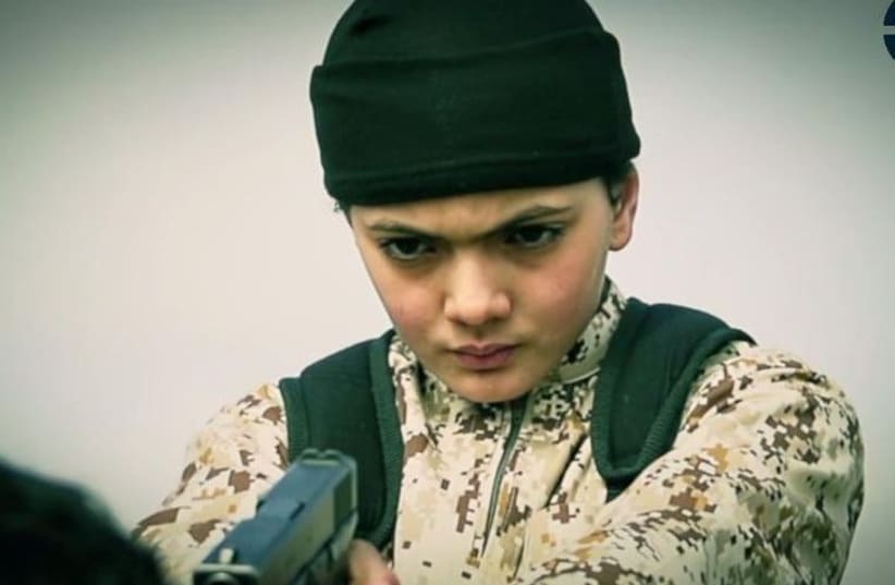 The young boy who appears in the ISIS video moments before purportedly executing 'an Israeli spy' (photo credit: screenshot)