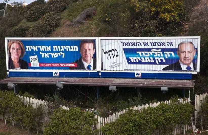 Prime Minister Benjamin Netanyahu, Isaac Herzog and Tzipi Livni are depicted on Likud and Zionist Union campaign billboards in Tel Aviv March 15 (photo credit: REUTERS)