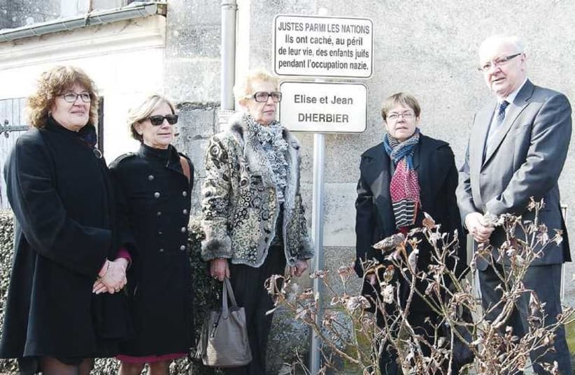 Annette Bonnet-Waldman (3rd from left) and Maryse Delagneau-Dherbier (2nd from right) stand beside a plaque erected in Boulleret, France, honoring Jean and Elise Dherbier, who ‘adopted’ Annette during the Nazi occupation (photo credit: BOULLERET MUNICIPALITY)