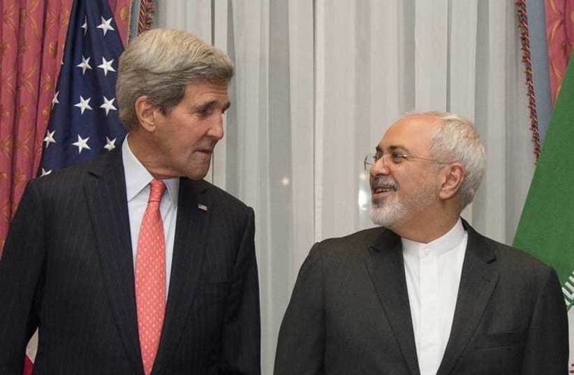 US. Secretary of State John Kerry (L) and Iran's Foreign Minister Mohammad Javad Zarif pose for a photograph before resuming talks over Iran's nuclear programme in Lausanne March 16, 2015. (photo credit: REUTERS)