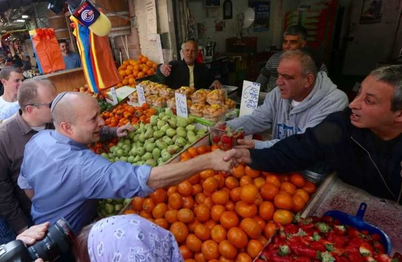 Bayit Yehudi leader Naftali Bennett campaigns at Mahane Yehuda shuk, Jerusalem's open air market‏ (photo credit: MARC ISRAEL SELLEM/THE JERUSALEM POST)