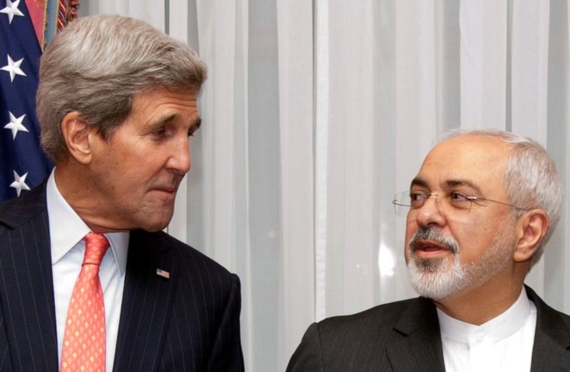US Secretary of State John Kerry (L) and Iran's Foreign Minister Mohammad Javad Zarif pose for a photograph before resuming talks over Iran's nuclear program in Lausanne March 16, 2015. (photo credit: REUTERS)