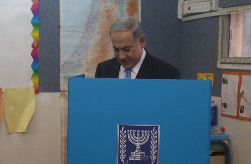 Prime Minister Benjamin Netanyahu votes in national election, March 17, 2015 (photo credit: MARC ISRAEL SELLEM)