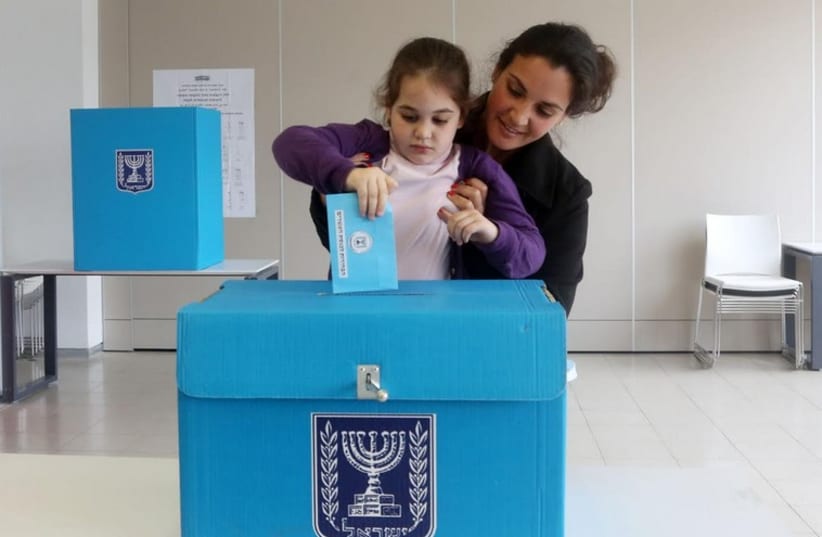 A child casts her mother's vote (photo by Marc Israel Sellem) (photo credit: MARC ISRAEL SELLEM)