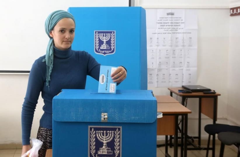A woman casts her vote in the March 2015 elections (photo credit: MARC ISRAEL SELLEM)