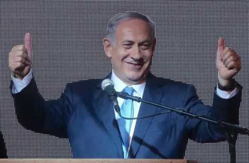 Prime Minister Benjamin Netanyahu gestures during his victory speech at Likud headquarters (photo credit: MARC ISRAEL SELLEM)
