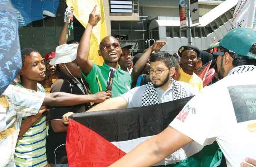 Students wear keffiyehs and hold Palestinian flags in solidarity. (photo credit: Courtesy)