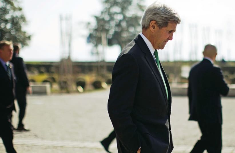 John Kerry walks in Lausanne on Tuesda (photo credit: REUTERS)
