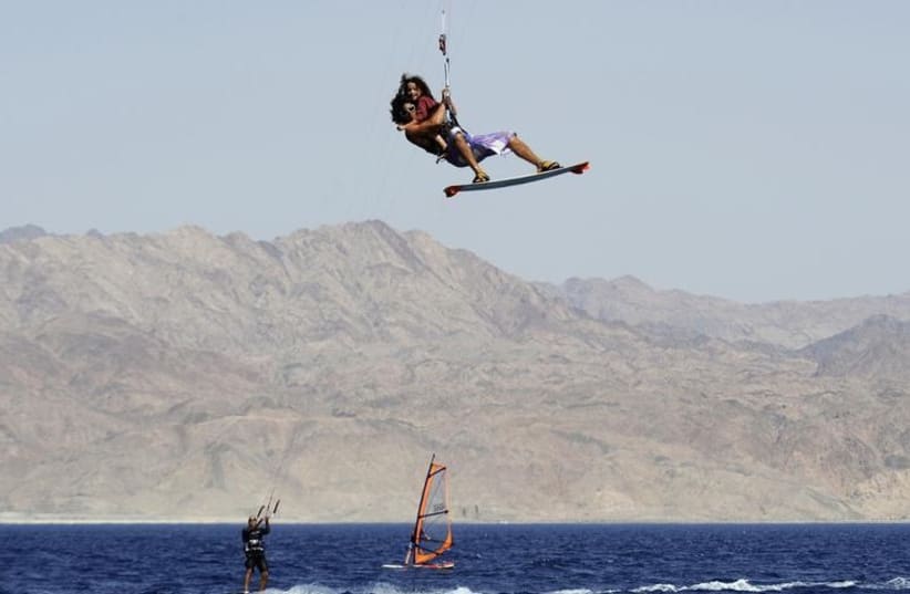 Israeli kite surfer Eli Zarka gets airborne with five-year-old Michael Smila (R) in Eilat (photo credit: REUTERS)