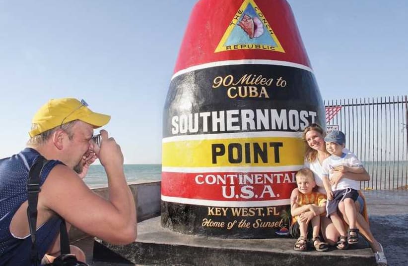 A FAMILY POSES at the southern end of Key West, Florida (photo credit: STACEY MORRIS)