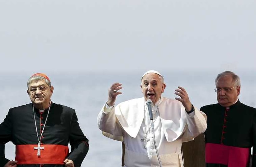 Francis (C) gestures as he speaks during a meeting with youths at the seafront during his pastoral visit in Naples  (photo credit: REUTERS)