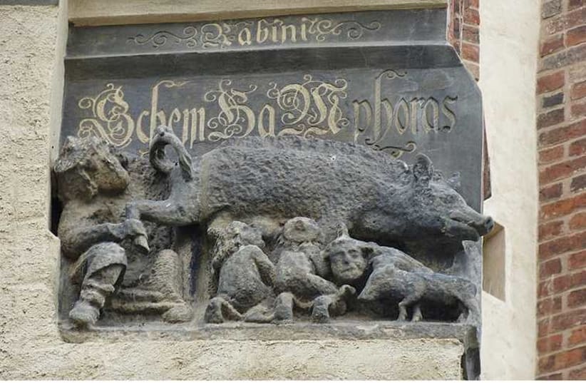 This carving on the facade of Martin Luther’s church in Wittenberg, Germany, shows Jews suckling at a sow’s teat.  (photo credit: JTA)