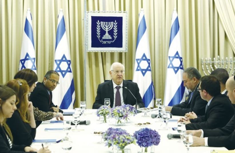 President Reuven Rivlin consulting with Yisrael Beytenu representatives (photo credit: DAVID VAAKNIN)