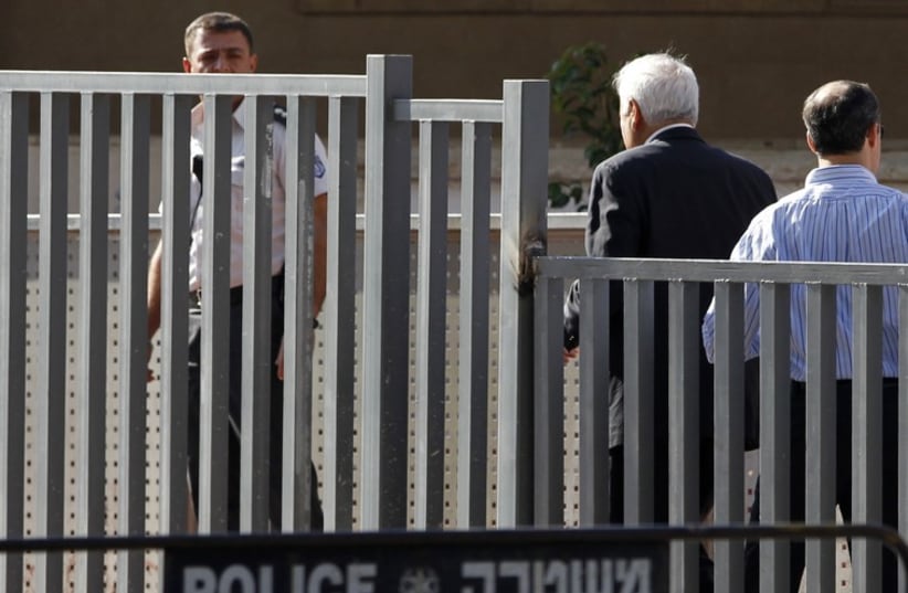 Former Israeli president Moshe Katsav walks towards the entrance to Maasiyahu prison in Ramle, near Tel Aviv, December 7, 2011 (photo credit: REUTERS)