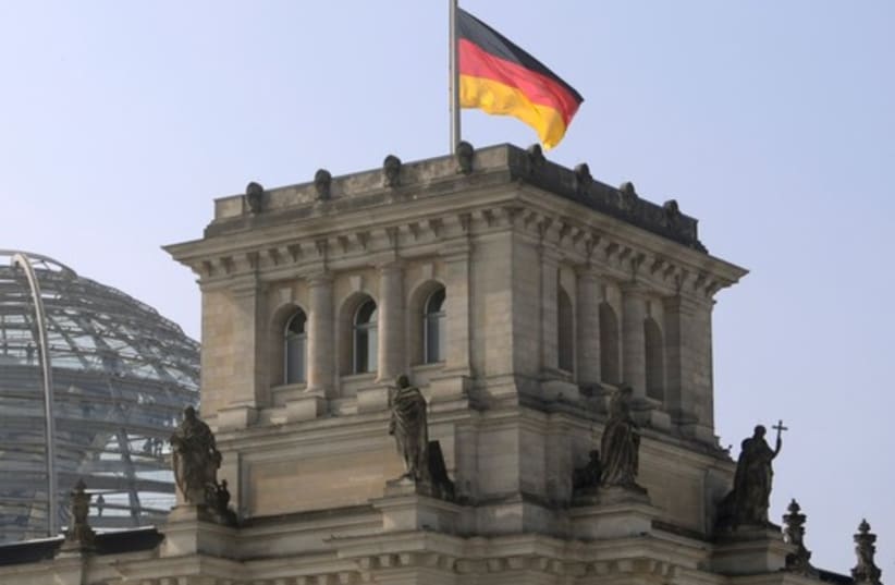 German flag flutters half-mast on top of the Reichstag building, the seat of the German lower house of parliament Bundestag in Berlin, March 25 (photo credit: REUTERS)