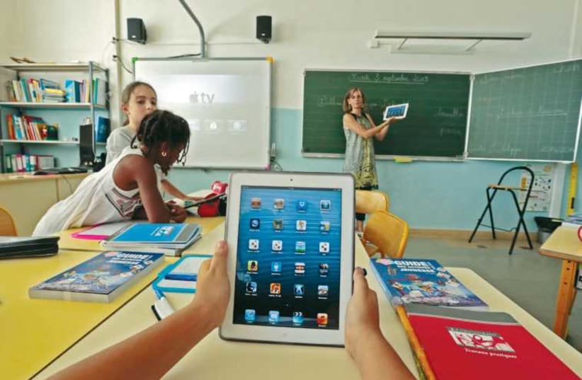 Elementary school children use electronic tablets. (photo credit: REUTERS)