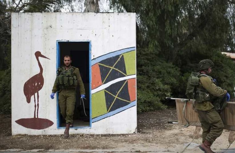 SOLDIERS LEAVE a bomb shelter in Kibbutz Mefalsim during a surprise drill near the border with the Gaza Strip on Sunday. (photo credit: REUTERS)