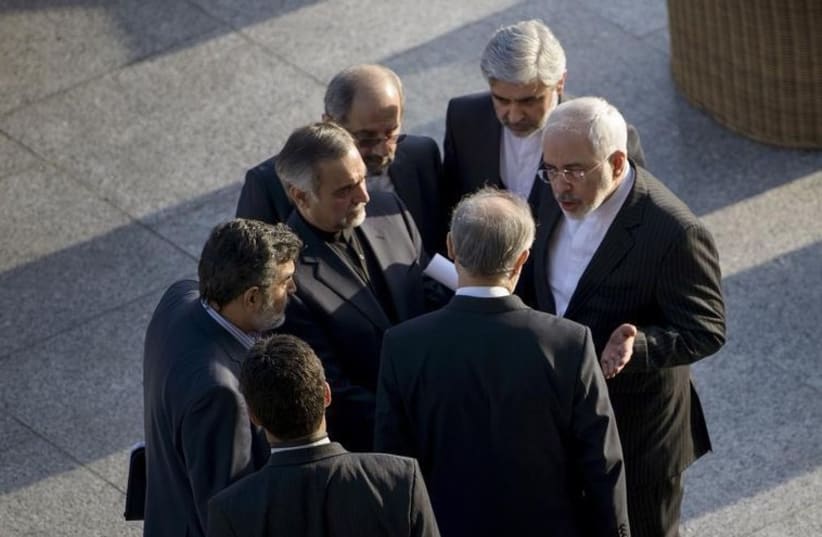 Iranian Foreign Minister Javad Zarif (R) and Head of Iranian Atomic Energy Organization Ali Akbar Salehi talk while other members of their delegation listen after a meeting with US Secretary of State John Kerry (photo credit: REUTERS)