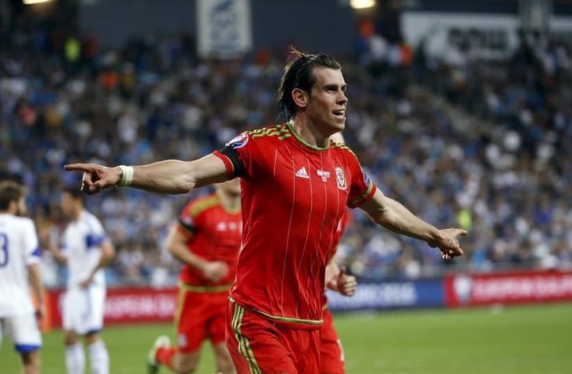 Wales’ Gareth Bale celebrates scoring a goal against Israel during their Euro 2016 Group B qualifying soccer match at the Sammy Ofer Stadium in Haifa (photo credit: REUTERS)