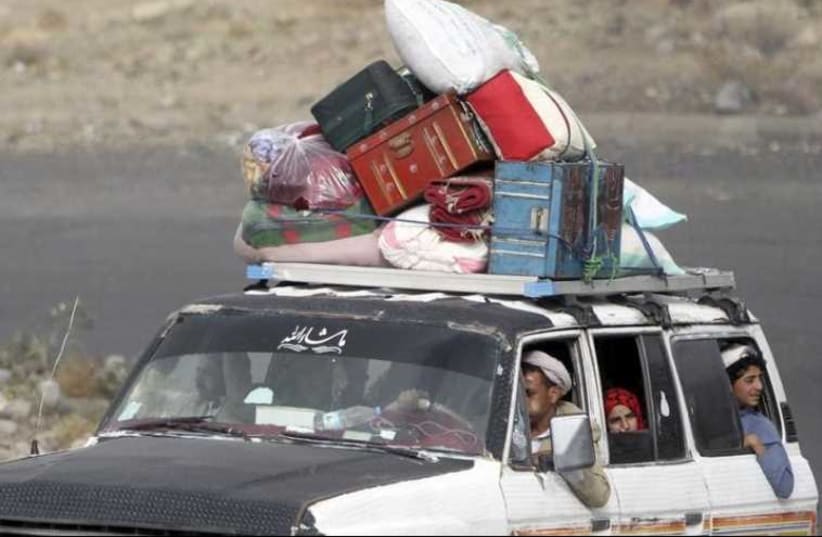 People flee Sanaa with their belongings fearing renewed air strikes. (photo credit: REUTERS)