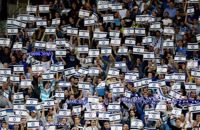 Israel fans hold placards during their Euro 2016 Group B qualifying soccer match against Wales at the Sammy Ofer Stadium in Haifa. (photo credit: REUTERS)